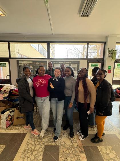 Grupa osób na korytarzu przegląda ubrania