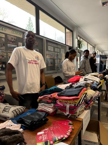 Grupa osób na korytarzu przegląda ubrania